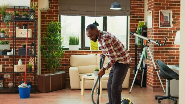 African American Partner Using Vacuum Clean Dust Living Room Doing — Stock fotografie