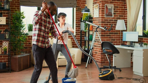 Young Couple Doing House Chores Singing Listening Music Spring Cleaning — Stok fotoğraf