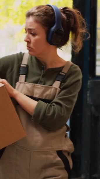 Vertikální Video Zaměstnankyně Přesouvá Skladové Krabice Regálech Poslouchá Hudbu Sluchátkách — Stock video