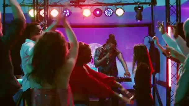 Dj在派对上戴着耳机 混杂着音乐 在舞池里和一群人聚会 年轻人喜欢与朋友共舞 使用音响器材 手持射击 — 图库视频影像