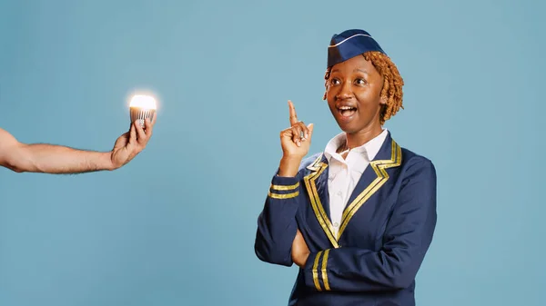 Young Air Hostess Turning Lightbulb New Idea Feeling Pensive Blue — Stock Photo, Image