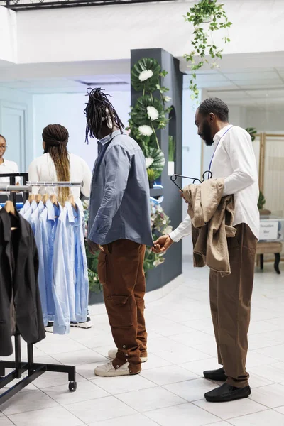 Clothing Store Employee Examining Shirt Customer Checking Fit African American — Stock Photo, Image