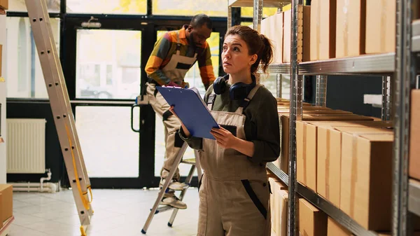 Female Depot Worker Checking Stock List Storage Room Analyzing Racks — Stock Photo, Image