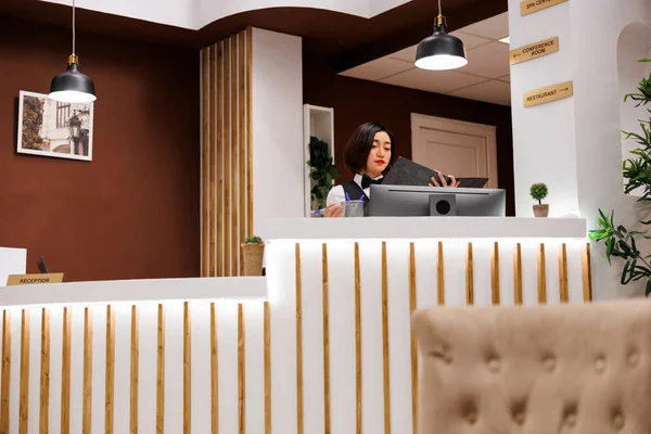 Asian Worker Checking Booking Enquiries Reception Desk Preparing Welcome Guests — Stock Photo, Image
