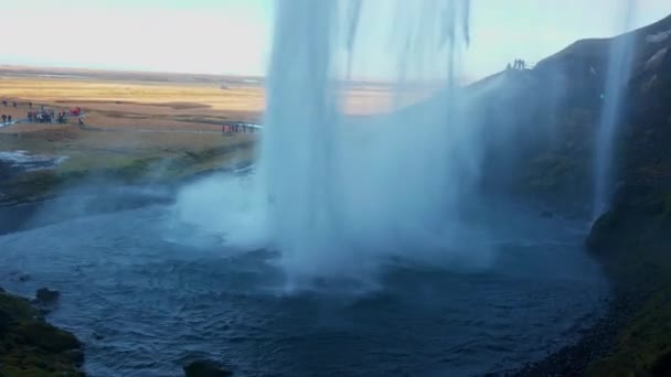アイスランドの丘を流れる水と大きな北欧のカスケードSeljalandsfoss 崖から落ちる川の流れと壮大な風景 スカンディナヴィアカスケード 手持ち撮影 — ストック動画