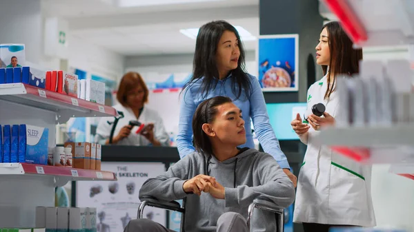 Male Wheelchair User Coming Pharmacy Buy Pills Receiving Help Asian — Stock Photo, Image
