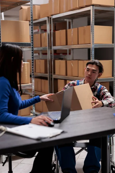 Warehouse Manager Taking Parcel Worker Wheelchair Create Invoice Laptop Post — Stock Photo, Image