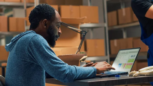 Male Entrepreneur Analyzing Stock Products Orders Doing Inventory Laptop Warehouse — Stock Photo, Image