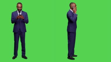 İş adamı internet sitesini karıştırıyor, telefon görüşmesinde sohbet ediyor, akıllı telefonu kullanarak uzaktan iletişim kuruyor ve sosyal medyada geziniyor. Yeşil ekranda cep telefonuyla çalışan erkek çalışan.