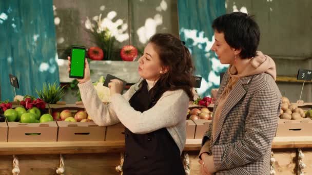 Two Women Looking Greenscreen Display Smartphone Checking Chroma Key Template — 비디오