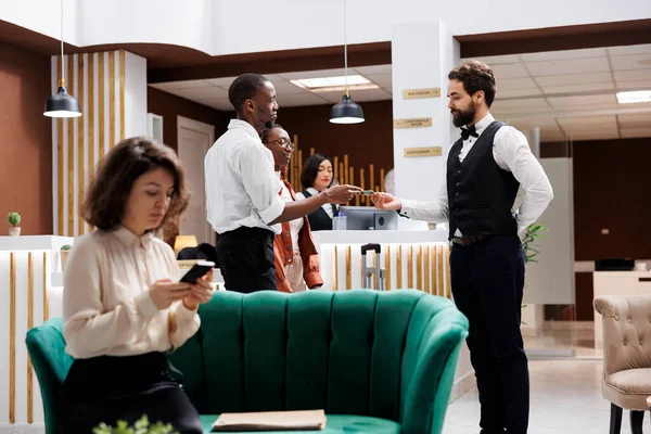 Hotelowy Konsjerż Bierze Pieniądze Człowieka Przyjmuje Walizki Pomaga Torbami Rejestracji — Zdjęcie stockowe