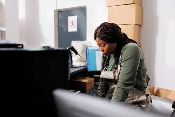 非裔美国人主管分析笔记本电脑上的仓库物流 在仓库的商品库存工作 准备客户发货定单的仓库员工 — 图库照片