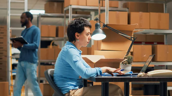 Female Employee Working Shipping Stock Storehouse Shelves Using Products Laptop — Stockfoto