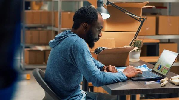African American Man Analyzing Stock Orders Doing Inventory Laptop Warehouse — Fotografia de Stock
