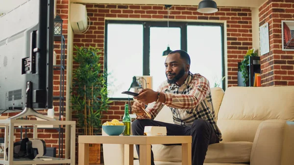African American Guy Eating Noodles Living Room Sitting Television Watching — Foto Stock