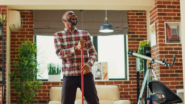 African American Adult Mopping Living Room Wooden Floors Dancing Acting — Foto Stock