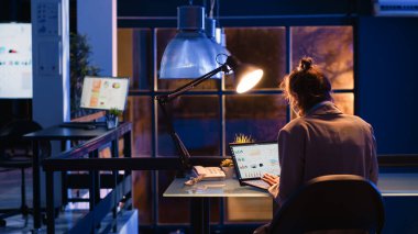 Young employee analyzing financial statistics on laptop, working on marketing strategy and company growth. Female manager planning corporate investment to increase profit in office.