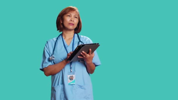Lisanslı Hemşire Koruyucu Önlük Giyip Tablete Tıbbi Veriler Yüklüyor Şinden — Stok video