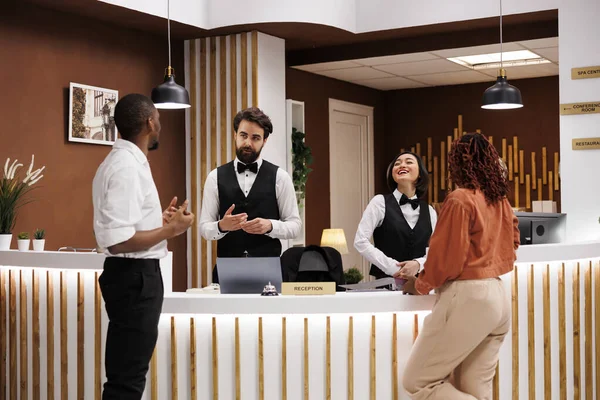 Diverse Workers Helping Hotel Guests Working Reception Desk Providing Advice — Stock Photo, Image