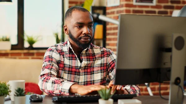 stock image Employee concentrating on finishing up important job tasks, remotely working from stylish apartment personal office. Focued teleworker typing on computer keyboard, close up