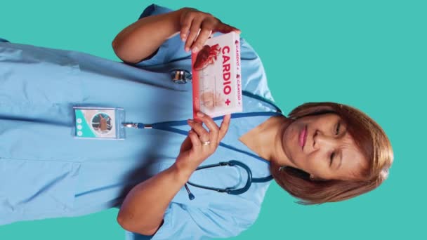 Nurse Holding Cardiovascular Tablets Box Reading Informations Pharmaceutical Package Healthcare — Stock Video