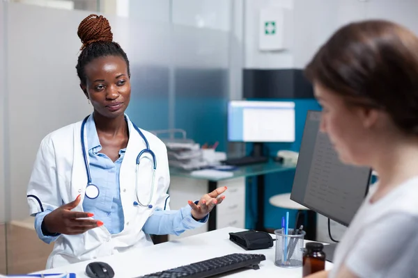 African American Doctor Talking Patient Offering Check Consultation Medical Office — Stock Photo, Image