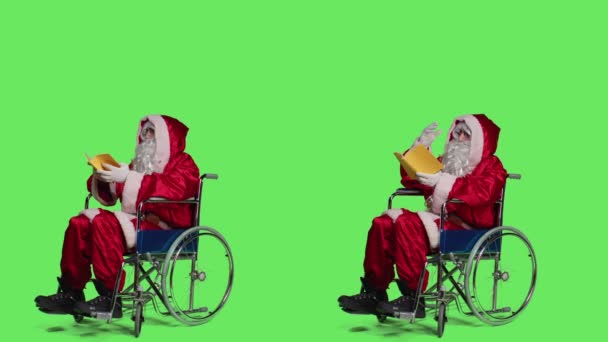 Santa Wheelchair Reads Book Enjoying Lecture Novel Story Greenscreen Full — Stock Video