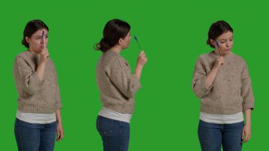Focused woman brainstorming ideas to find solution, thinking about best decision to work in front of camera. Young person acting pensive and thoughtful in studio, confident female model.