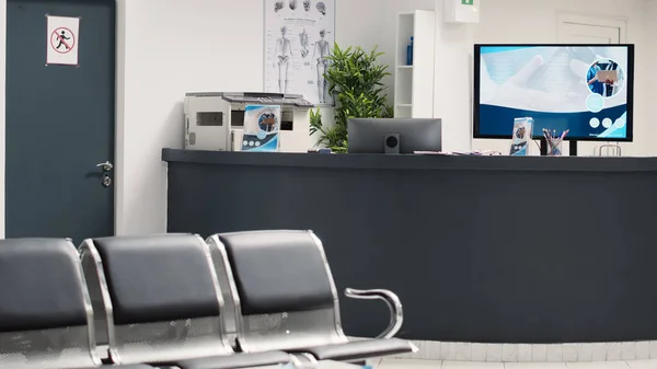 stock image Hospital reception counter in hallway and waiting room, medical checkup examination in health care clinic. Waiting area with seats at clinical diagnostic center, emergency service.