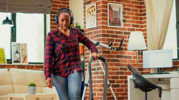 African American Woman Listening Music Headset Vacuuming Floors Living Room — Stock Photo, Image