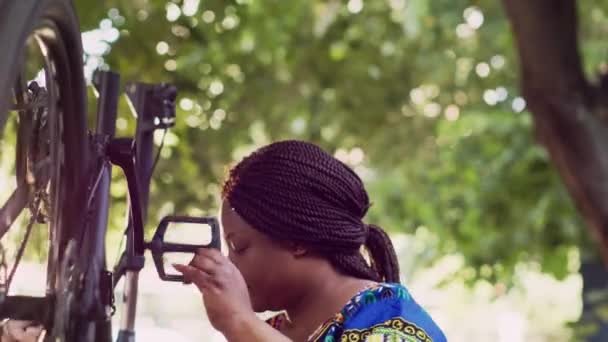 Determined Black Woman Testing Inspecting Bike Wheel Pedals Yard Summer — Stock Video