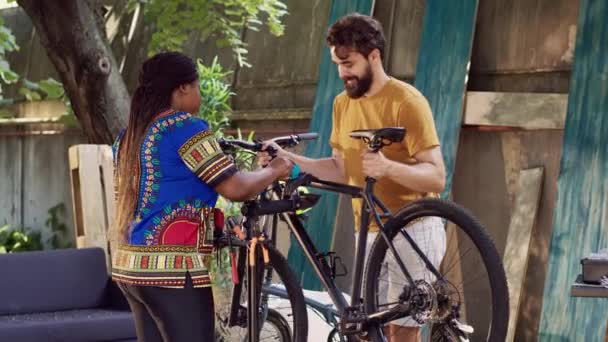 Szabadban Egészséges Afro Amerikai Segíti Kaukázusi Barátját Kerékpár Javításában Aktív — Stock videók