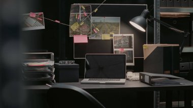 Criminal evidence board in investigation office, map filled with research photos and case clues. Police archive space with background check papers and crime suspects, law officer expertise.