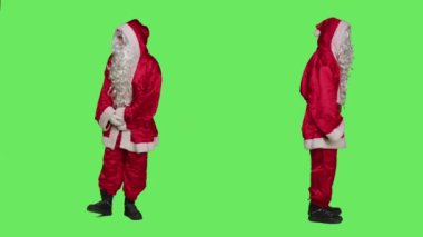 Noel Baba kostümü kol saatini kontrol eder, zamana bakar ve yeşil perde için sabırsızlanır. Noel Baba kameraların önünde yürüyor, mevsimlik kutlamalar.