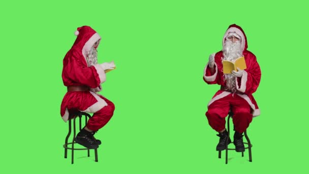 Santa Claus Character Reads Fiction Sitting Chair Using Book Knowledge — Stock Video