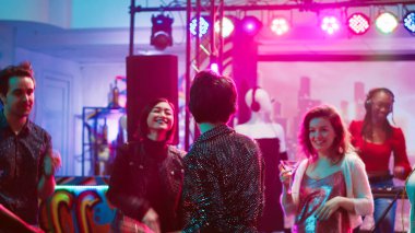 Diskotekte dans eden eğlenceli insanlar, canlı disko müziği, dans pistinde parti. Genç bir arkadaş grubu gece hayatının tadını çıkarıyor, eğlenmek için gece kulübüne gidiyorlar. Üçayak atışı.