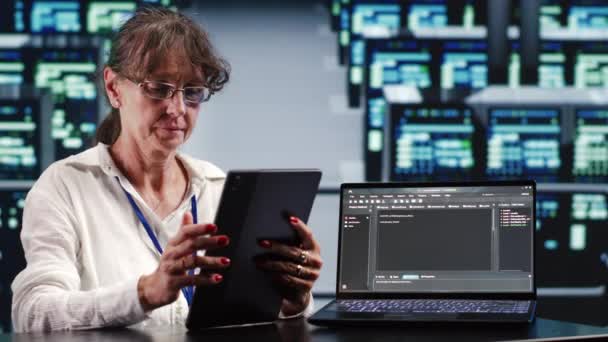 Starsza Kobieta Pracująca Zaawansowanym Technologicznie Miejscu Pracy Realizująca Zadania Tablecie — Wideo stockowe