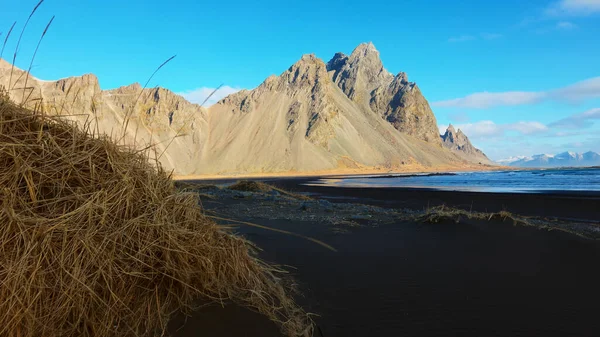 北極圏には黒い砂のビーチがあり 巨大なベストラホーン山脈が壮大なアイスランドの景色を作り出しています アイスランドの半島に丘と雄大な海の海岸線 手持ち撮影 — ストック写真