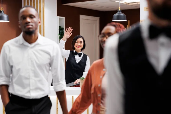 Happy Receptionist Waving Guests Doing Check Out Process Wishing Them — Stock Photo, Image