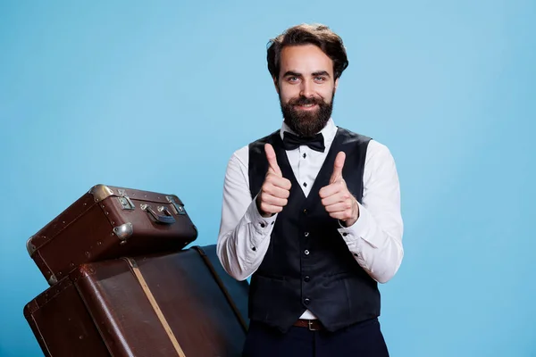 Smiling Bellboy Does Thumbs Sign While Wearing Formal Hotel Attire — Stock Photo, Image