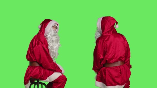 Święty Nick Siedzący Krześle Pozujący Zielonym Ekranie Święty Mikołaj Ucieleśniony — Wideo stockowe