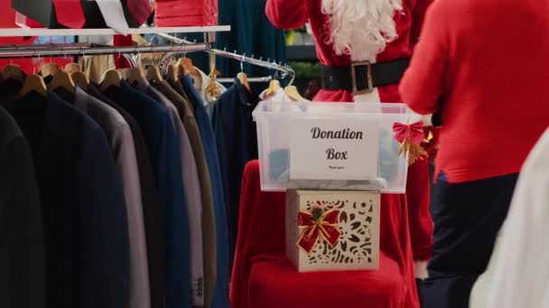 Employee Dressed Santa Claus Collecting Unneeded Clothes Shoppers Donation Box — Stock Video