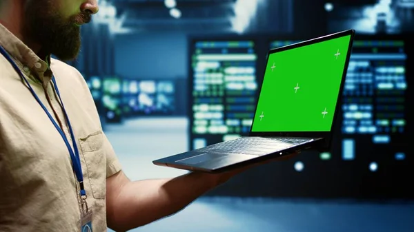 Specialist using green screen laptop to check server clusters configuration settings, close up. Engineer checking event logs in monitoring software to find faulty data center hardware root cause