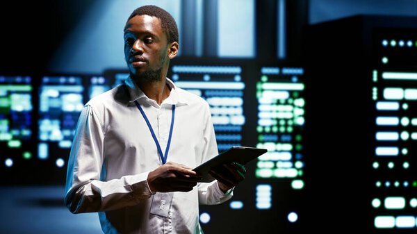 IT programmer using tablet to run diagnostics on server hardware clusters doing complex calculations, enabling artificial intelligence to process massive datasets for AI applications and workloads