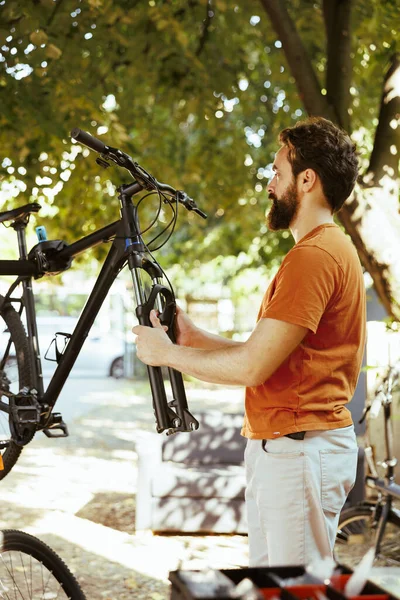 Committed Young Active Man Delicately Fine Tuning Bike Front Fork — Stock Photo, Image