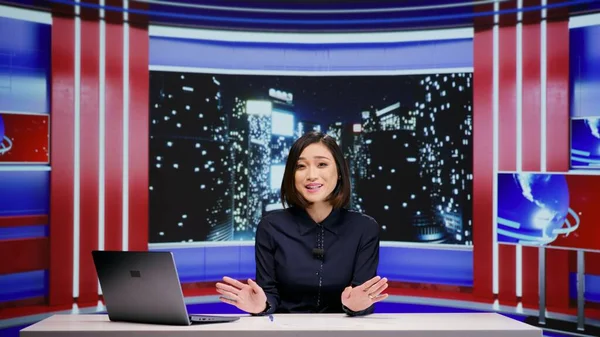 Media broadcaster hosting talk show late at night, discussing about important global events on live television program. Asian woman working as journalist with entertainment tv segment.