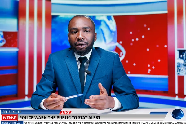 stock image Breaking news serial killer on the loose, african american reporter warns citizens to stay alert and cautious after criminal escaped prison. News broadcaster working on global communications.