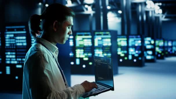 Certified Asian Technician Running Code Laptop Maintenancing Upgrading Data Center — Stock Video