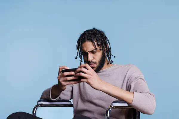 Focused Gamer Disability Playing Smartphone Tensed Facial Expression Concentrated Arab — Stock Photo, Image