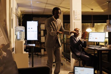 Neşeli mutlu işçi başlangıç ofisinde eğleniyor, komik dans hareketleri gösterirken müzik dinliyor. Şirket yatırım planında yönetici yönetici fazla mesai yapıyor. İş konsepti